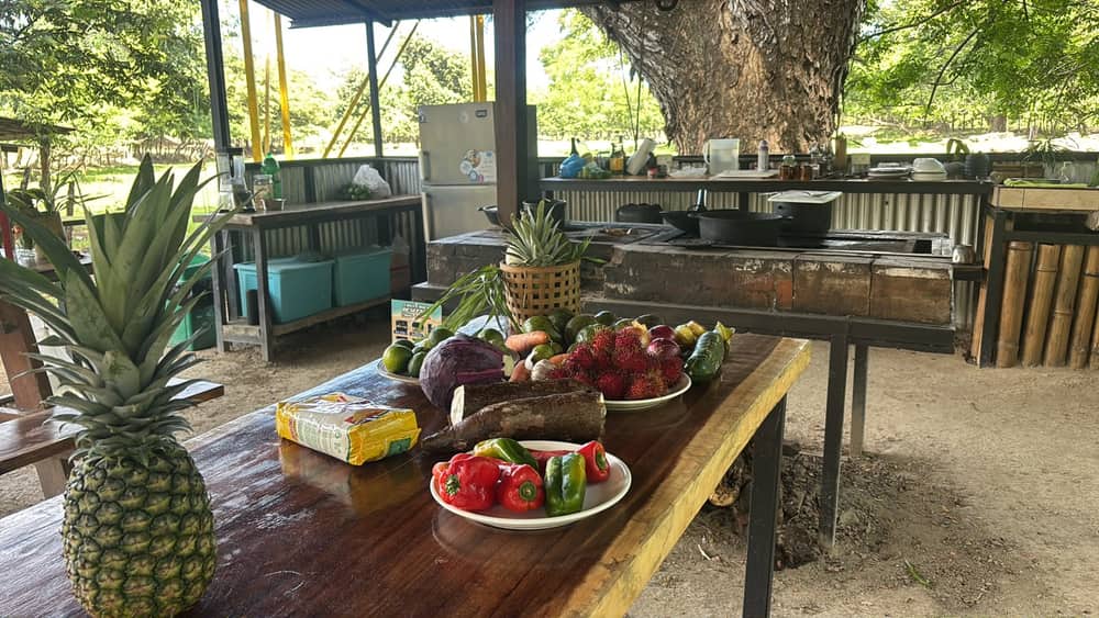 Piñas frescas y frutas de la finca sobre una mesa de madera